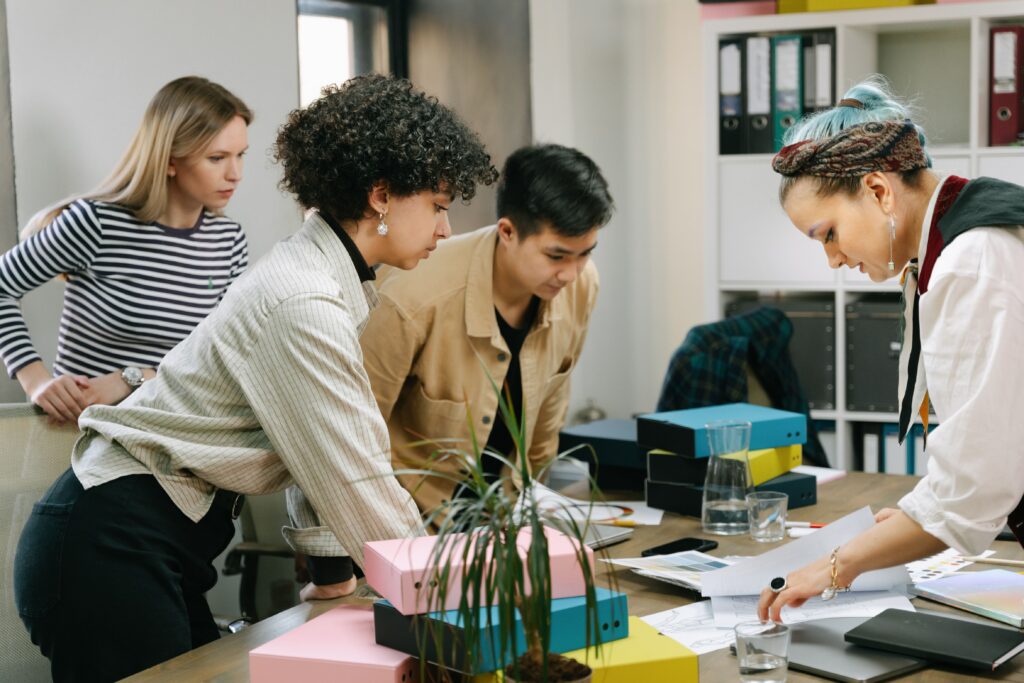 Diverse team members collaborating in a meeting and building trust through communication and teamwork.