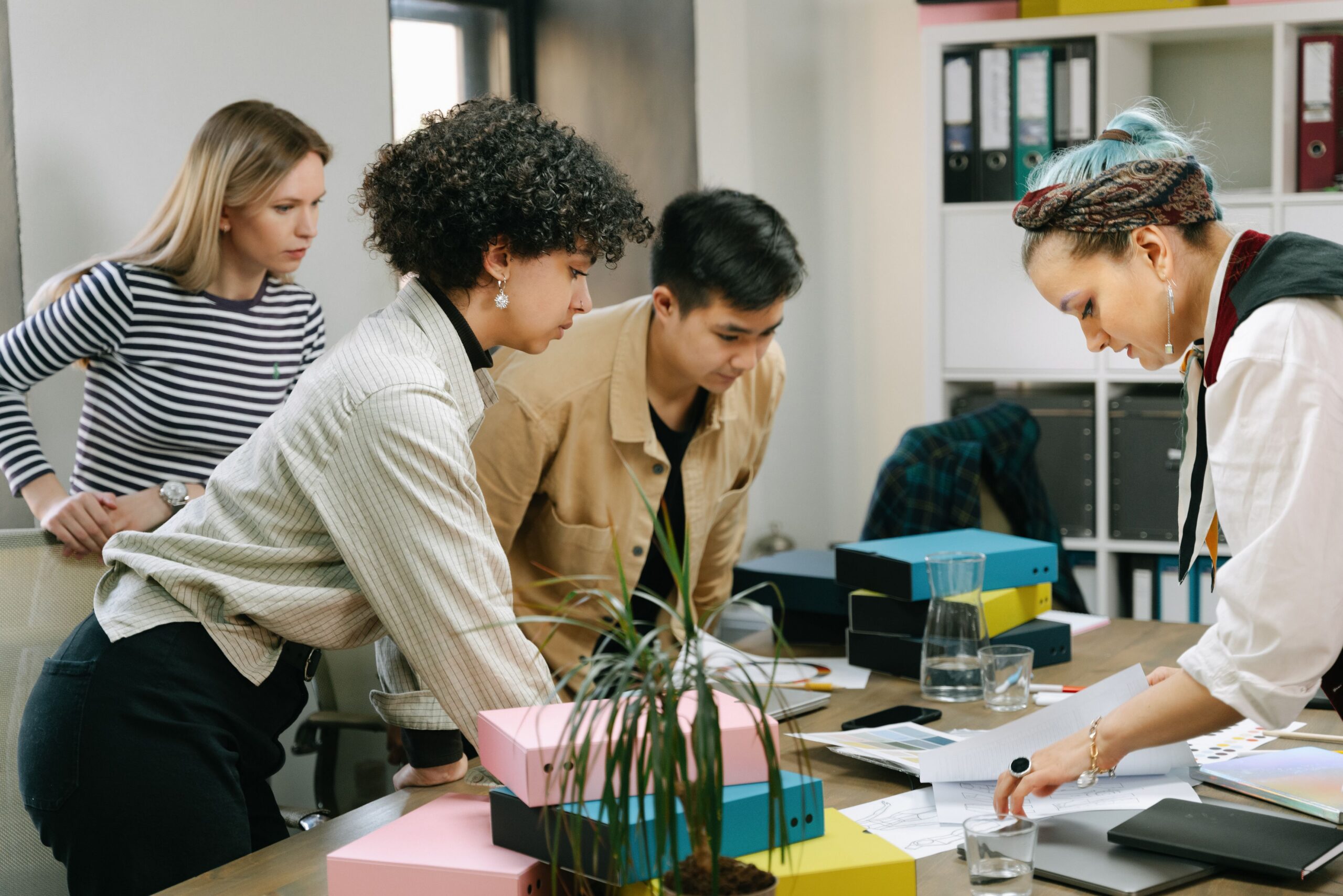 Diverse team members collaborating in a meeting and building trust through communication and teamwork.